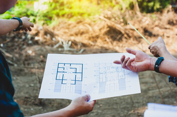 Group of contractors discuss land improvement planning for construction.