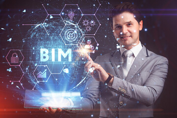 Wall Mural - The concept of business, technology, the Internet and the network. A young entrepreneur working on a virtual screen of the future and sees the inscription: BIM