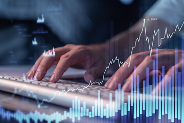 Hands typing the keyboard to research stock market to proceed right investment solutions. Internet trading and wealth management concept. Hologram Forex chart over close up shot.