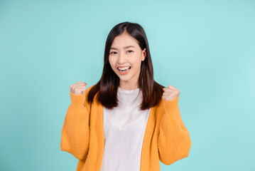 Dental of young asian woman wearing retainer braces glad emotion with white teeth increase confidence for healthy on blue background isolated, Happiness teenager smiling facial expression.