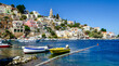 The water front on the Island of Symi with the church of The Annunciation standing on the hill above the fishing boats.  .
