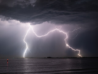 Wall Mural - double lightning strike in the water of the sea