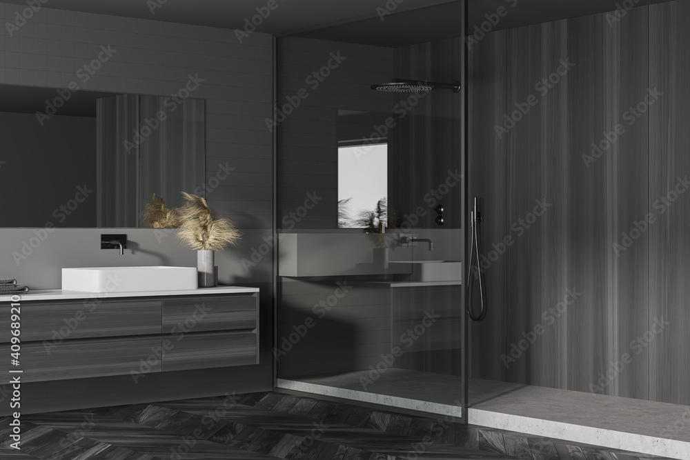 Interior of modern bathroom with dark gray and tiled walls, concrete and dark wooden floor, sink with vertical mirror and cabinets and shower stall. Concept of spa. 3d rendering - obrazy, fototapety, plakaty 