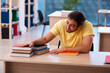 © Elnur - Young male student preparing for exams in the classroom