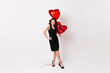 © Look! - Full length shot of elegant slim woman with party balloons. Glamorous girl celebrating valentine's day.