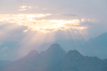 Wall Mural - Foggy mountain sunrise. Clouds in the morning over the mountains. Colorful travel background.