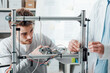 © StockPhotoPro - Engineers in the lab using a 3D printer