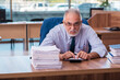 © Elnur - Old male employee working in the office