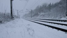 Snowfall On The Background Of Railway Tracks