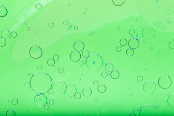 Oil mixed with water, abstract colorful background. Green background and texture.