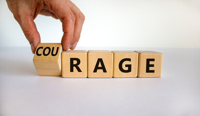 Rage or courage symbol. Businessman turns a cube and changes the word 'rage' to 'courage'. Beautiful white background. Copy space. Business and rage or courage concept.