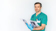 © nieriss - Attractive male doctor in a blue suit and a medical history of the patient with x-rays close-up on a white background. Banner with a caucasian doctor radiologist for advertising medical services.