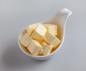 Wall Mural - pieces of butter in white bowl