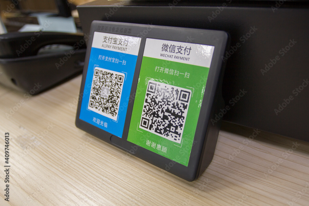 Shanghai, China - Aug 14, 2019: QR codes of WeChat Pay and Alipay, the two most popular mobile payment platforms in mainland China, side by side at the checkout counter in a drugstore.