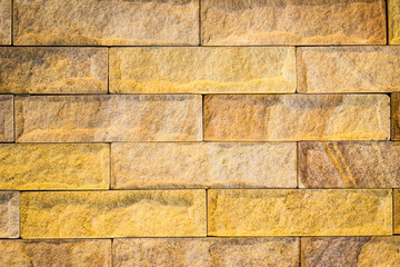 architectural background of brown and yellow rectangle terracotta bricks with line and texture patterns