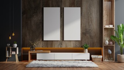 Poster mockup with vertical frames on empty dark wooden wall in living room interior with cabinet.