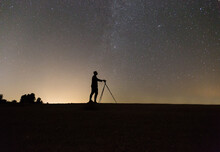 Silhouette Of Photographer Shooting Night Stars