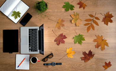 Poster - banner with gadgets: laptop, tablet, smartphone. notebooks, free space with autumn leaves