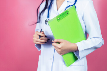 Medical healthcare professional beautiful doctor worker holding a clipboard, confident happy smiling successful with stethoscope working diagnosing examination health on isolated pink background