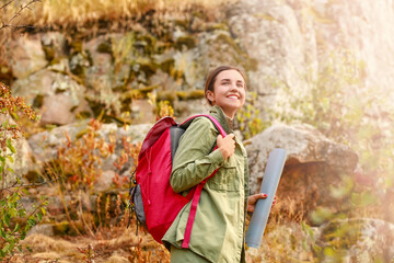 Wall Mural - Young female tourist in mountains