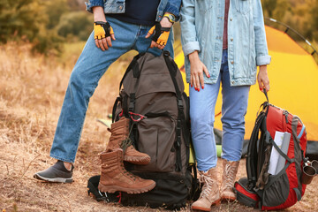 Wall Mural - Couple of young tourists near tent in countryside