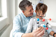 © epiximages - Father and son playing with atoms model, learning chemistry.