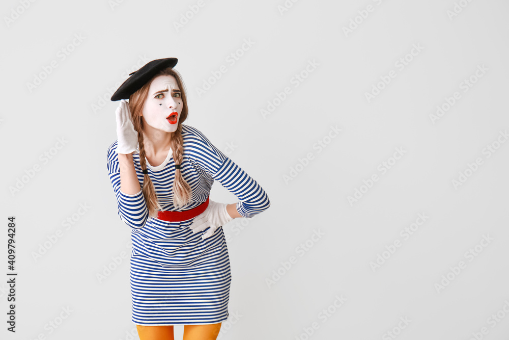 Female pantomimist on grey background