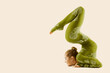 © inarik - Contortionist Flexible Circus Performer, Acrobat Dancer in Green Costume, Yoga Woman Gymnast Beige Background
