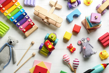 Sticker - Different toys on white wooden background, flat lay