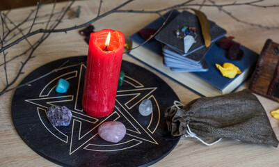 Altar with a pentagram to attract love, happiness, candle, stones, Tarot cards and witchcraft at home