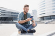© kite_rin - Young handsome man using smartphone in a city. Smiling student men texting on his mobile phone. Coffee break. Modern lifestyle, connection, business concept.