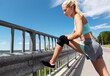 © Syda Productions - fitness, sport and healthy lifestyle concept - young woman stretching leg outdoors