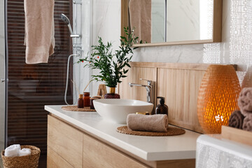 Poster - Vase with beautiful branches, candles and toiletries near vessel sink in bathroom. Interior design