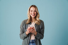 Cheerful Beautiful Blonde Girl Smiling And Using Mobile Phone