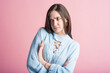 © Павел Костенко - Angry emotions of a brunette girl in the studio on a pink background