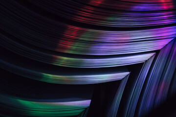 Fototapete - Close up Beautiful book pages in the multi color light on a night. Background pattern for design. Macro photography view.
