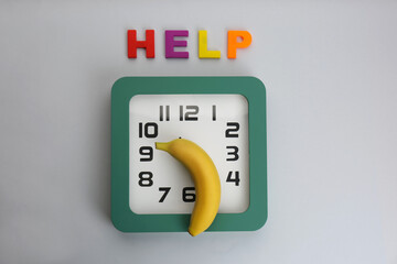 Wall Mural - Clock with banana and word HELP on grey background, flat lay. Potency problem concept