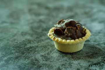 Chocolate cornflakes tart on cement ground. Close up desserts. Homemade desserts.