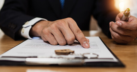 Wall Mural - Check and read contract thoroughly before signing, close up hand of businessman reading and checking business document and sign on paper