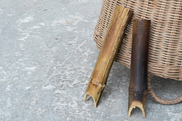 Two  bamboo rice leaning side by side wicker basket with vintage cement wall.