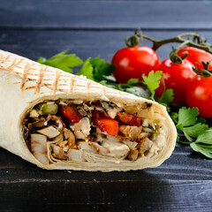 Sticker - Turkish doner kebab, shawarma, roll with meat and pita bread on a wooden background. Burrito with grilled chicken and vegetables, fajitas