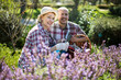 © caftor - Family work in the garden. Woman and man grow roses