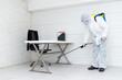 © Pornsak - Male medical staff wearing PPE uniforms to prevent COVID-19 from using a nebulizer. And use chemicals to disinfect at the office of the business company prevent the risk of the coronavirus outbreak.