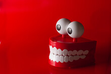 Clockwork Jaw With White Teeth On A Red Background
