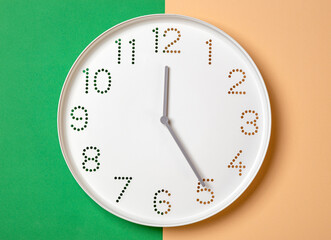 Wall Mural - wall clock on a colored background show five o'clock