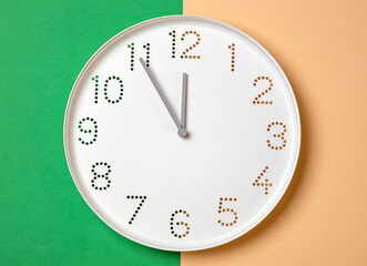 Wall Mural - wall clock on a colored background show eleven o'clock