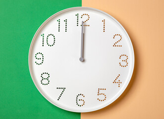 Wall Mural - wall clock on a colored background show twelve o'clock