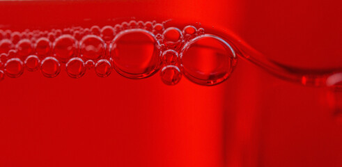 Canvas Print - Macro shot of soap bubbles on red background