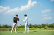 Group golfer sport course fairway.  People man lifestyle congratulation and shake hand after putting golf ball in hole on the green.  Asian man with friend playing  game shot in summer.