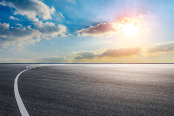 Race track road and sky clouds at sunset.Road ground background.